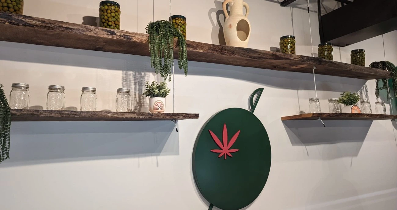 Shelves, Olive logo, and jars in Toronto weed dispensary